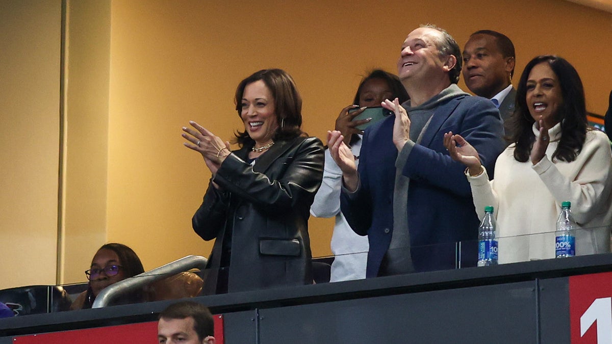 Vice President Kamala Harris and second gentleman Douglas Emhoff watch a football game