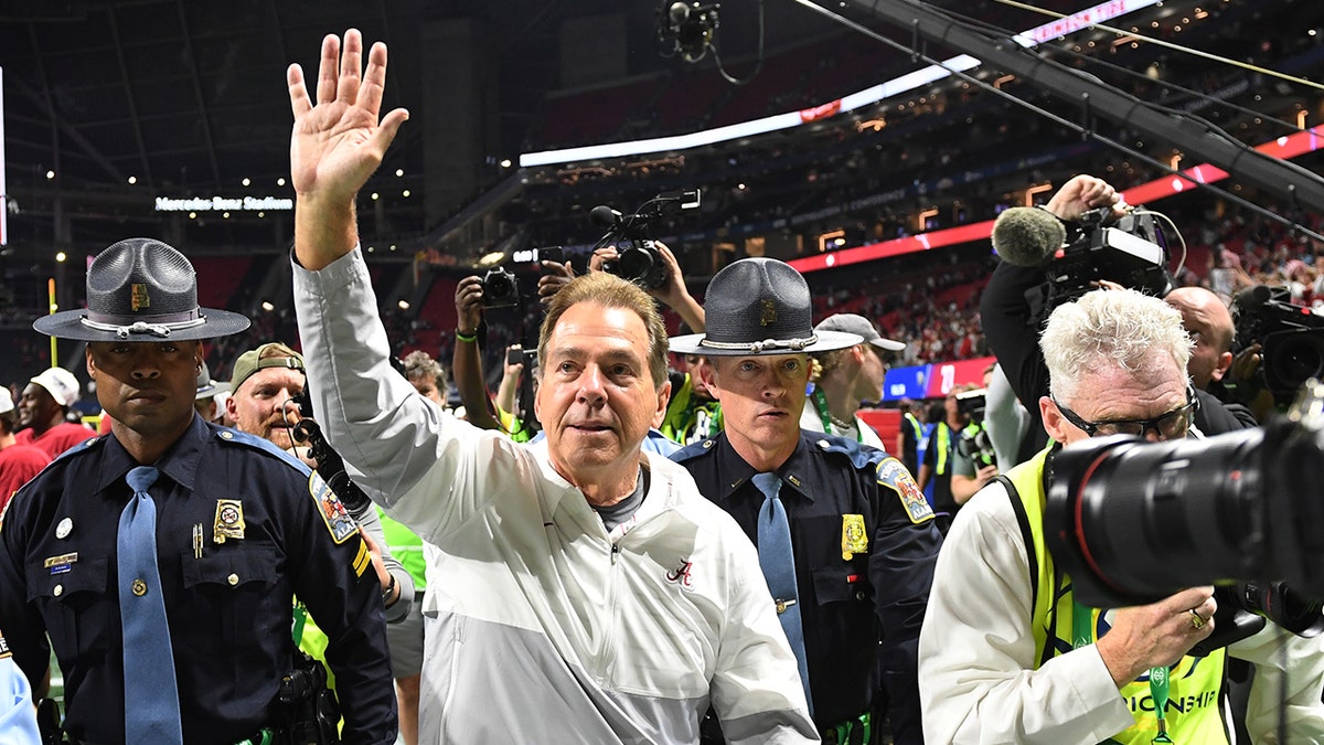 Nick Saban waves