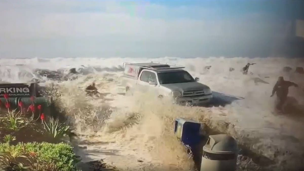 A screenshot of people being swept by a monster wave in California