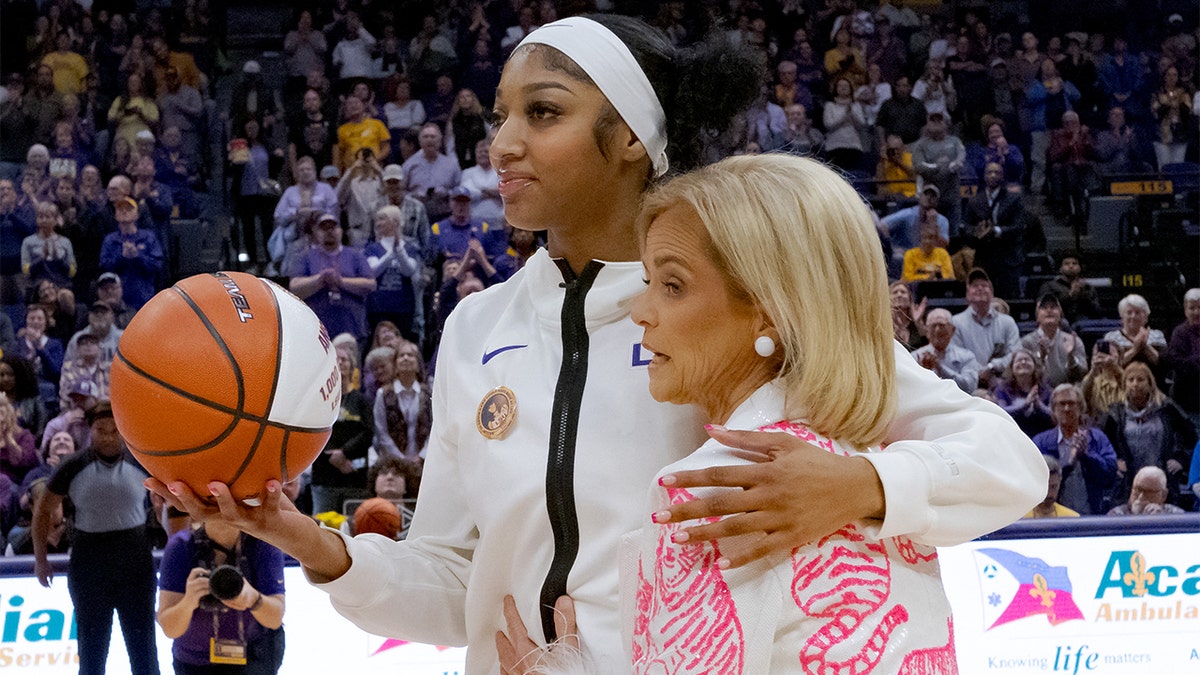 Angel Reese and Kim Mulkey share a hug