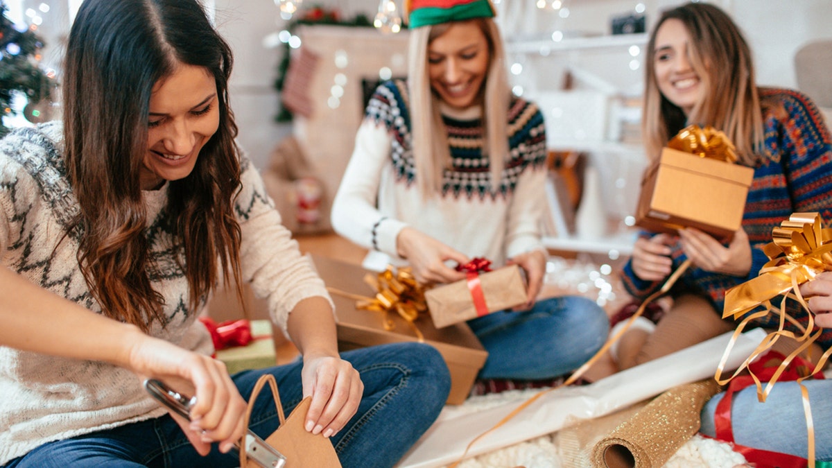 group of girls wrapping gifts