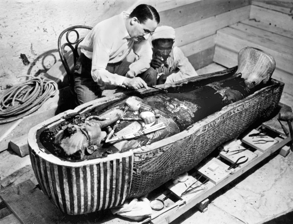 Howard Carter English egyptologist near golden sarcophagus of Tutankhamon in Egypt in 1922 
