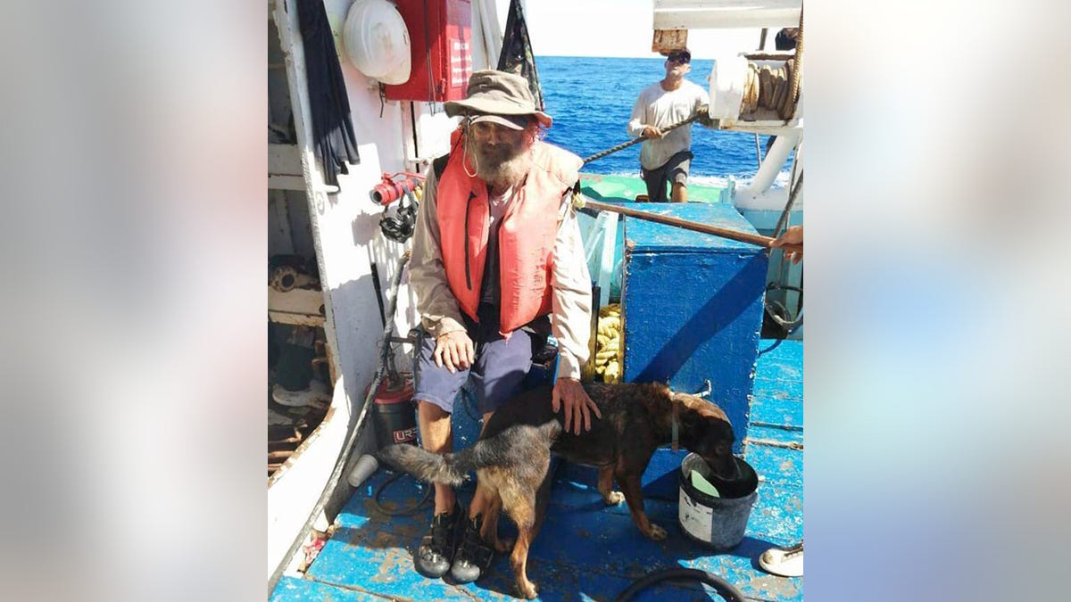 Tim Shaddock sits with his dog Bella