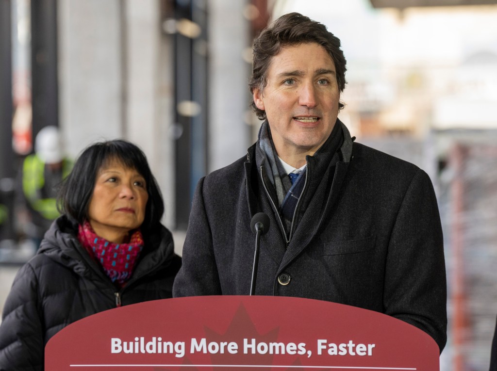 Toronto Mayor Olivia Chow, left, looks on as Canada's Prime Minister Justin Trudeau speaks at a housing announcement on Dec. 21.