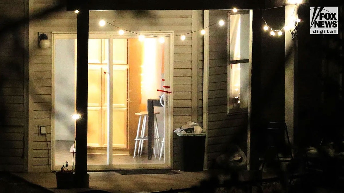 sliding glass door with lights on at night