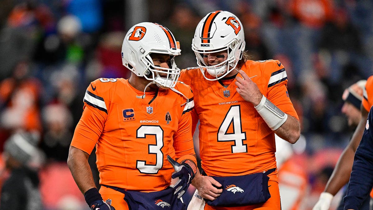 Russell Wilson and Jarrett Stidham warm up before a game