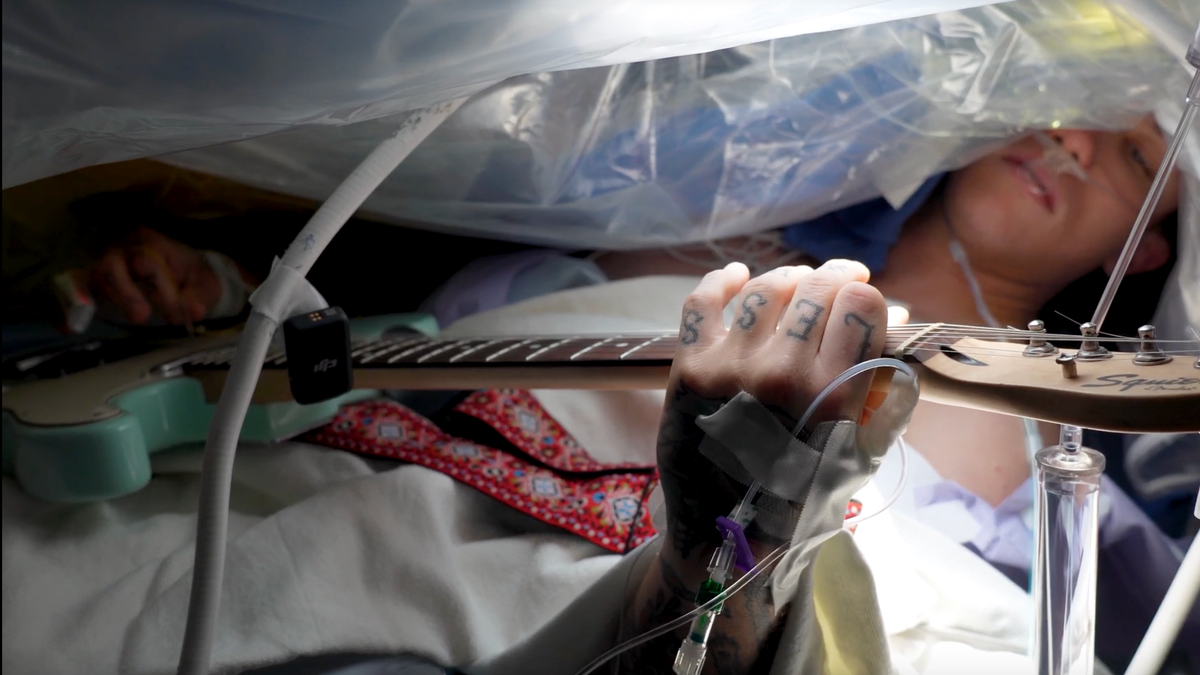 Patient playing guitar during surgery