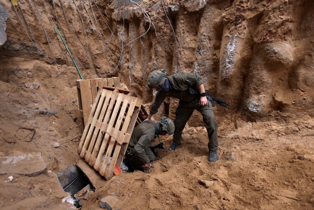  Israeli soldiers operate at the opening to a tunnel at Al Shifa Hospital compound in Gaza City, amid the ongoing ground operation of the Israeli army against Palestinian Islamist group Hamas, in the Gaza Strip, November 22, 2023.  