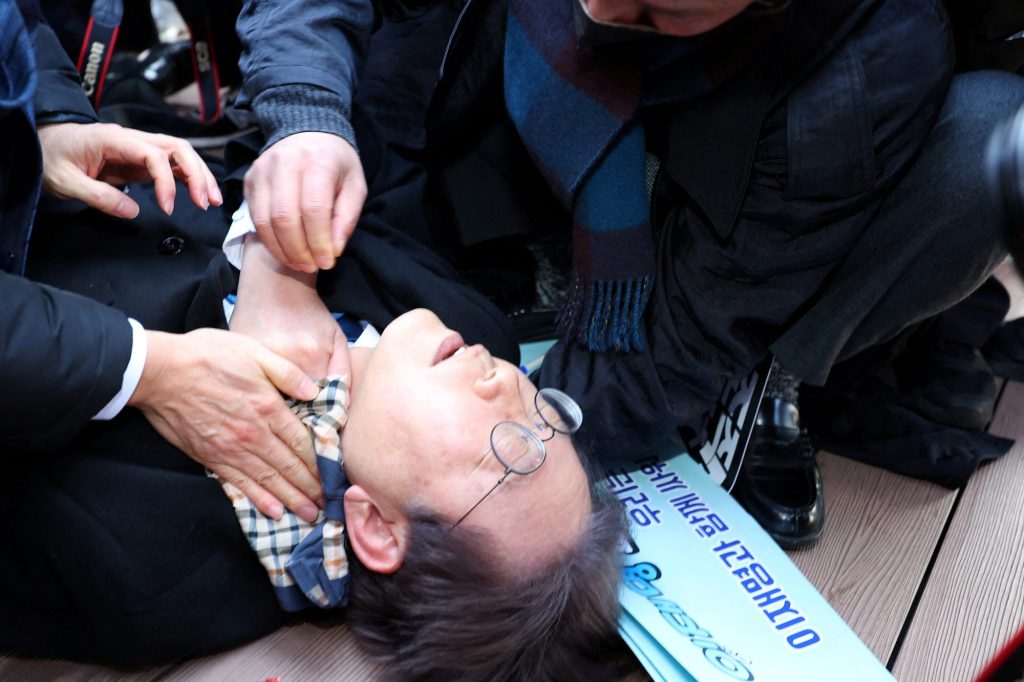 South Korea's opposition party leader Lee Jae-myung falls after being attacked by an unidentified man during his visit to Busan, South Korea, January 2, 2024