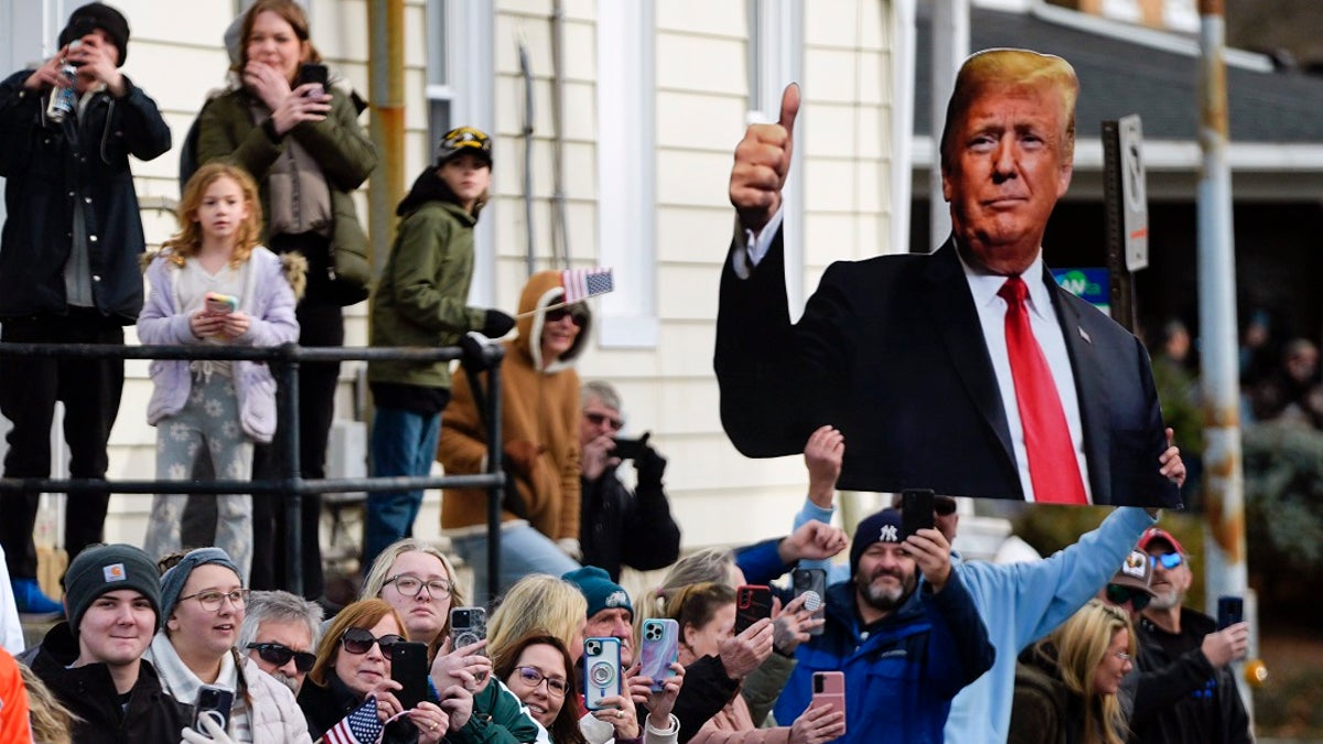 A spectator holds an image of former President Trump in Allentown