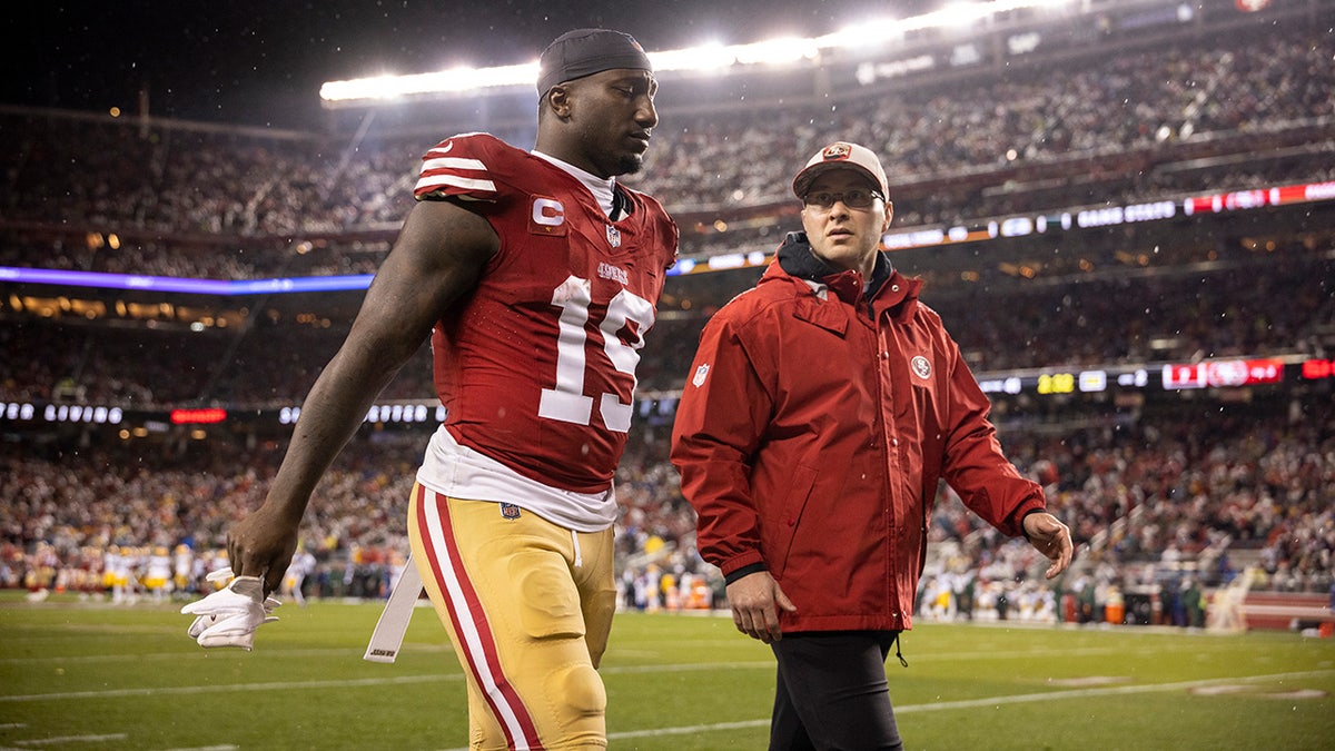 Deebo Samuel walks off field with trainer