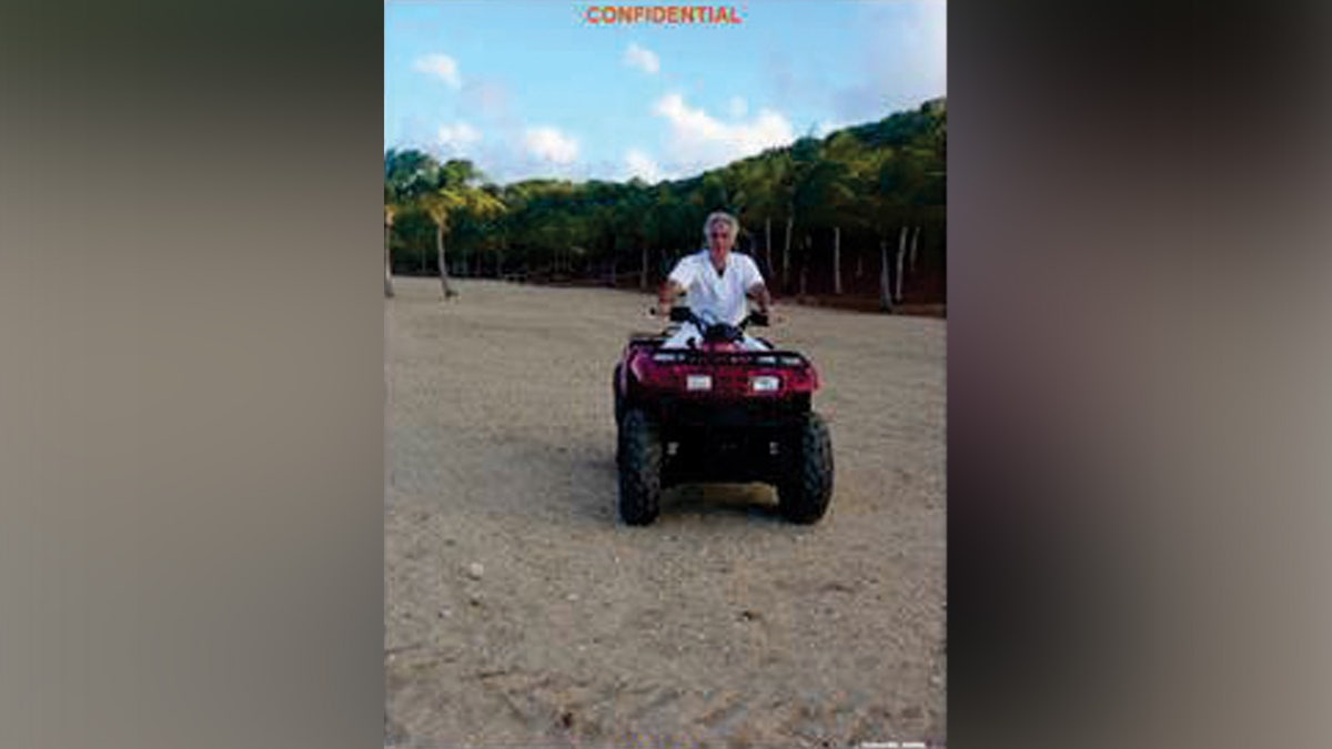 An evidence photo shows Jeffrey Epstein atop a four-wheeler on Little St. James Island