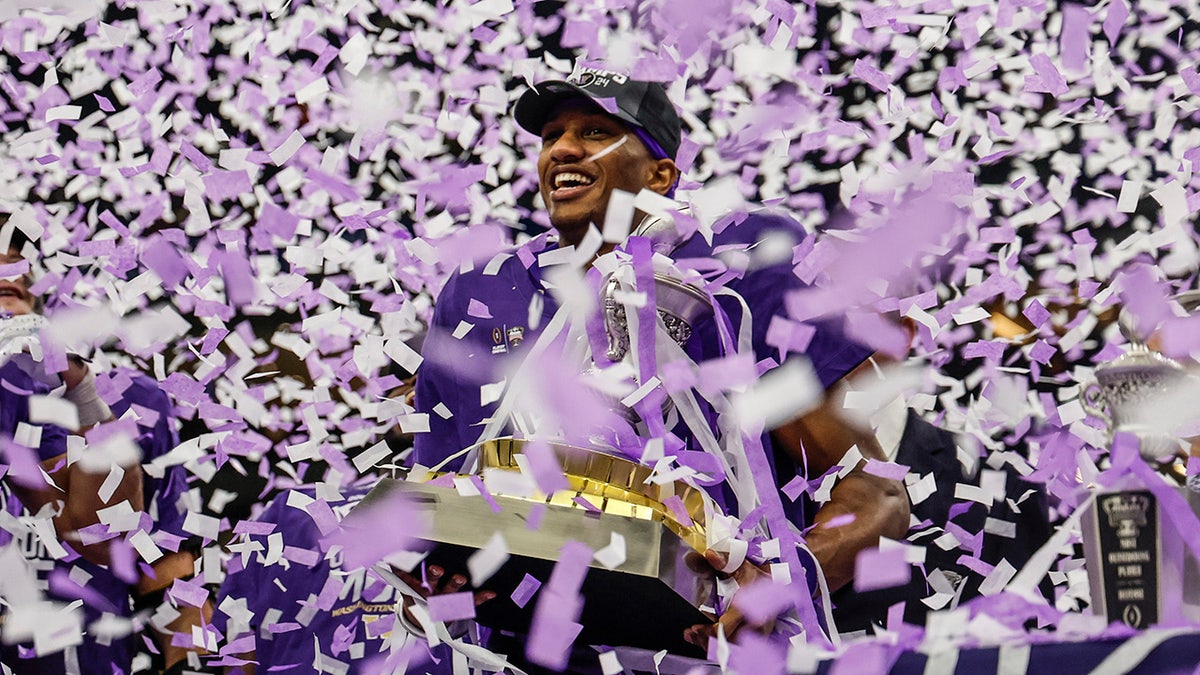 Michael Penix Jr with the trophy