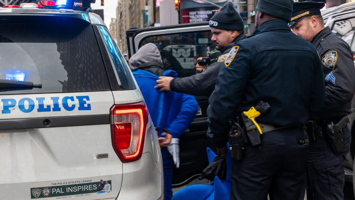 The NYPD arresting a man