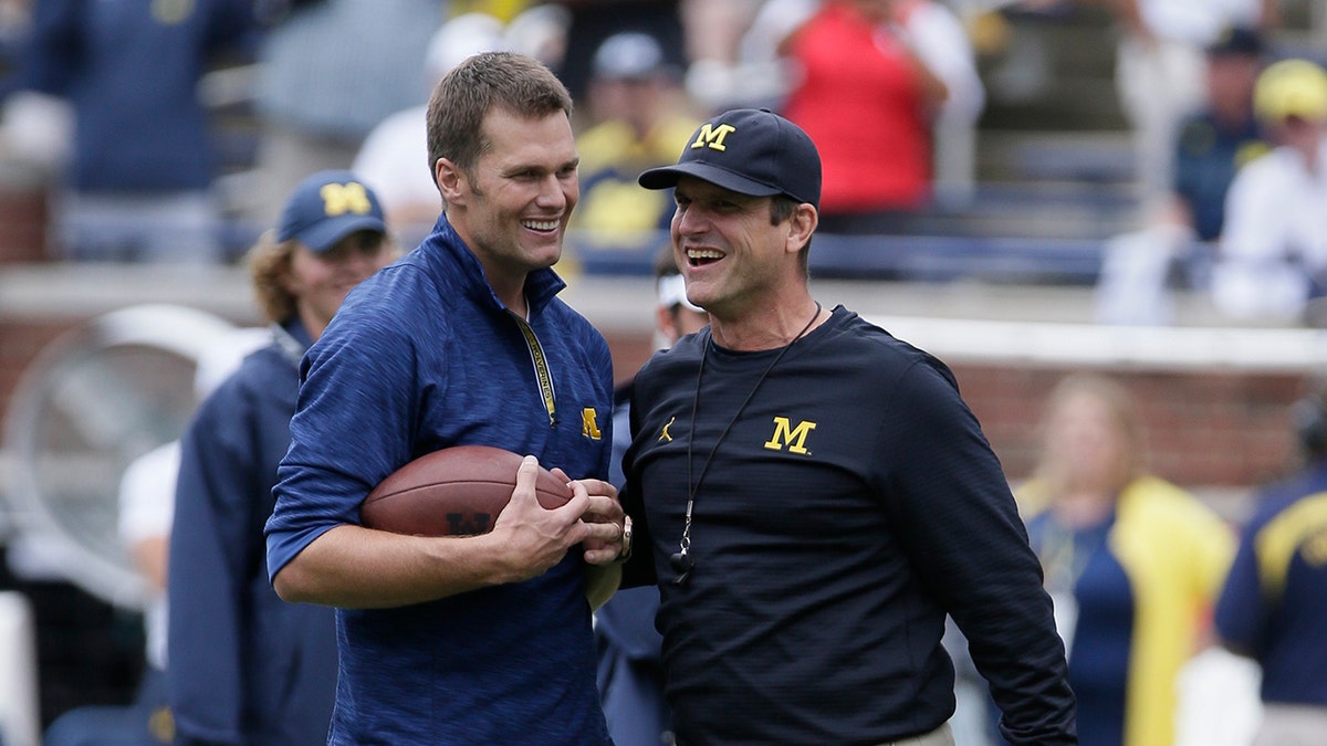 Tom Brady speaks to Jim Harbaugh