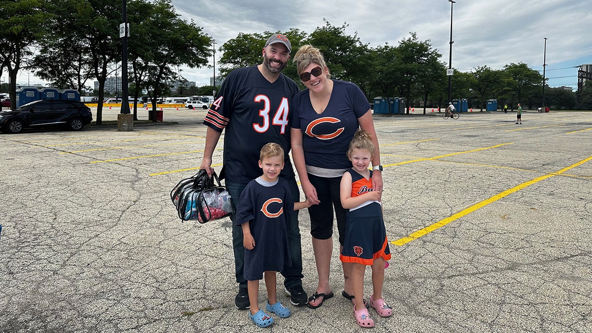 jenn, ryan and kids at a bears game