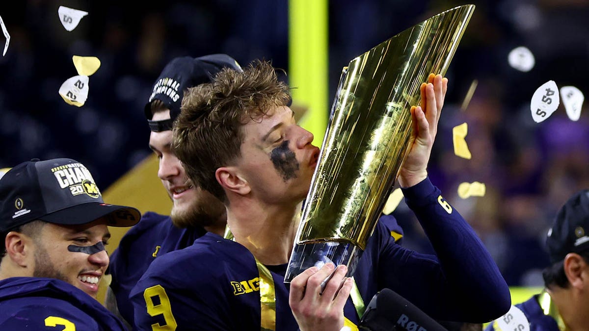 jj mccarthy kisses trophy 