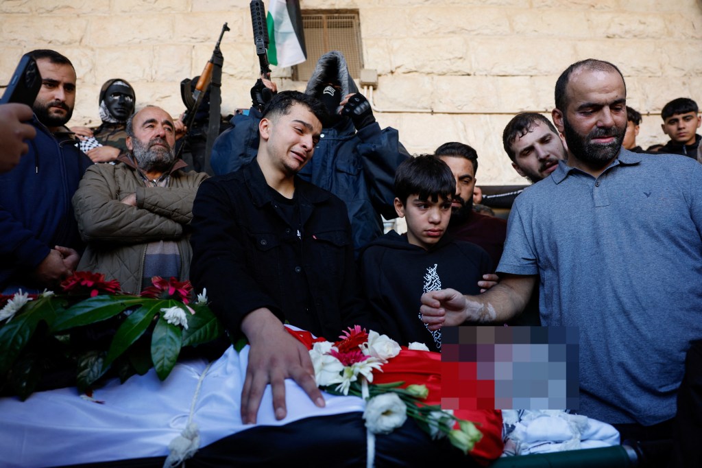 Mourners react next to the body of American-Palestinian Tawfiq Ajjaq