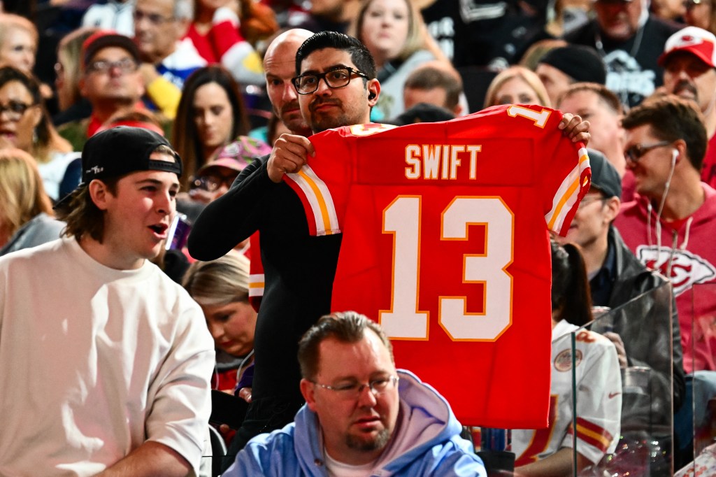 A fan holds up a Kansas City Chiefs jersey with Swift #13 during Super Bowl LVIII Opening Night at Allegiant Stadium in Las Vegas, Nevada.