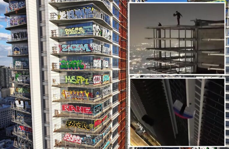 Parachuters leap from roof of graffiti-ridden abandoned Los Angeles skyscraper: video