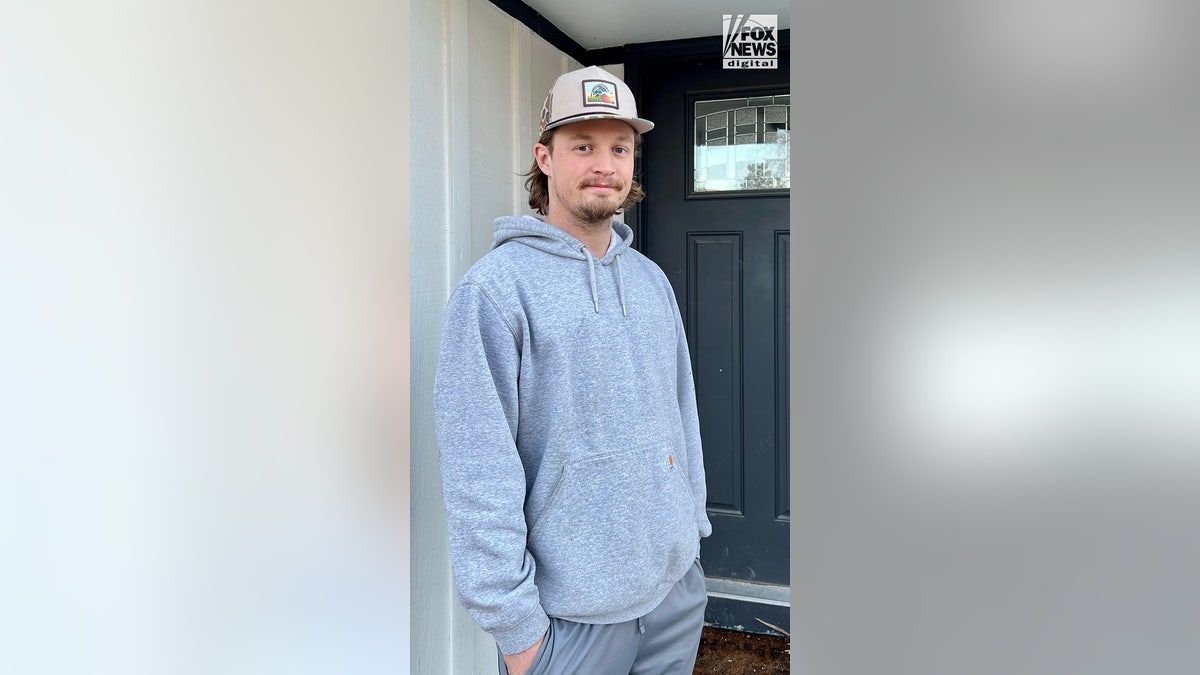 Ashton Brady poses for a photo on his front porch in Kansas City