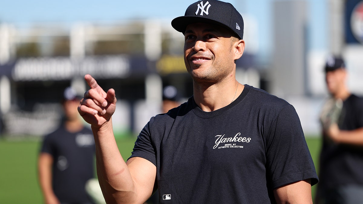 Giancarlo Stanton points into crowd