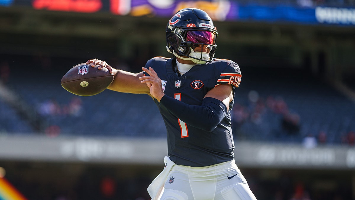 Justin Fields throws ball