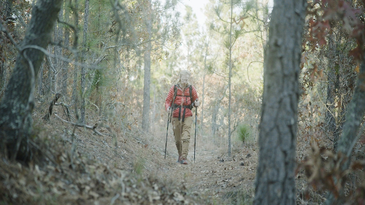 Brandon Dowell hiking on a trail