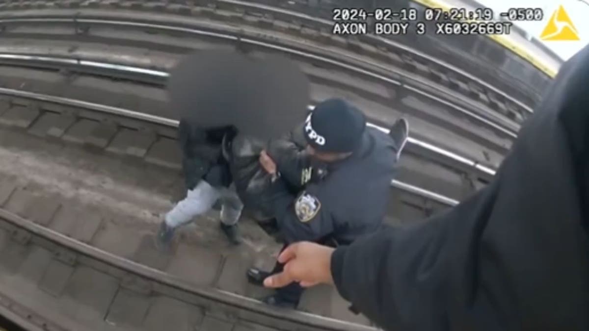 A man being rescued from subway tracks in new York City