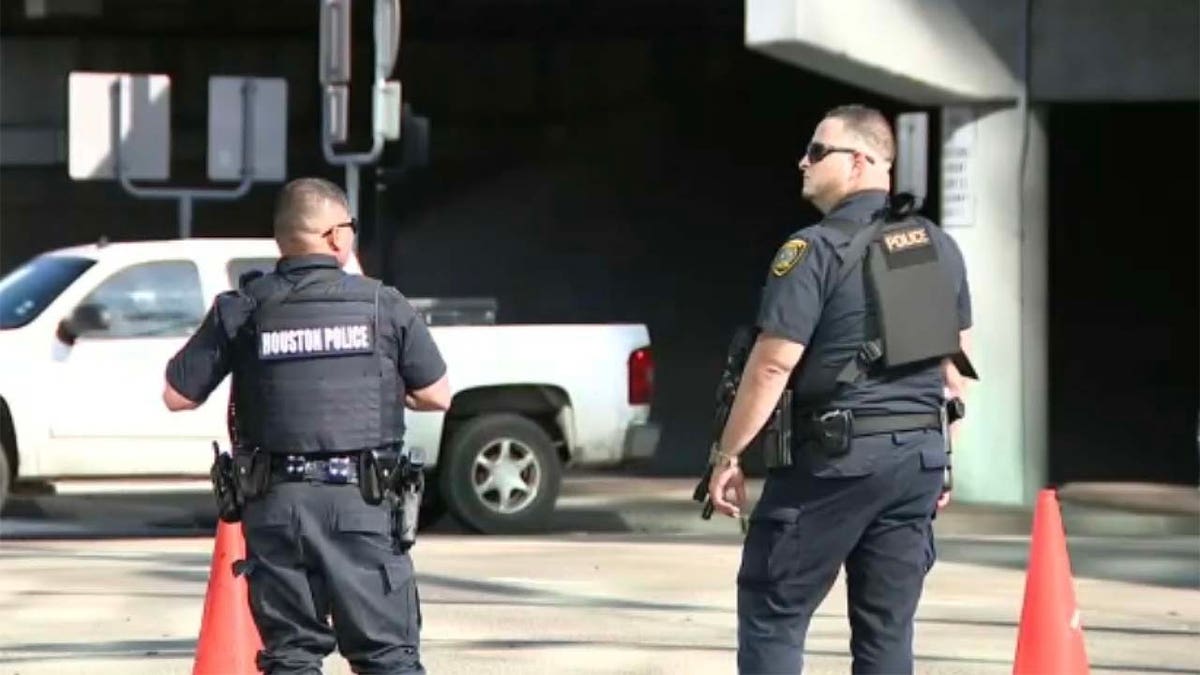 Two police officers walking at scene