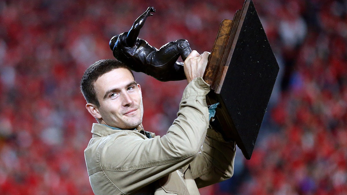 Stetson Bennett holds the Burlsworth Trophy