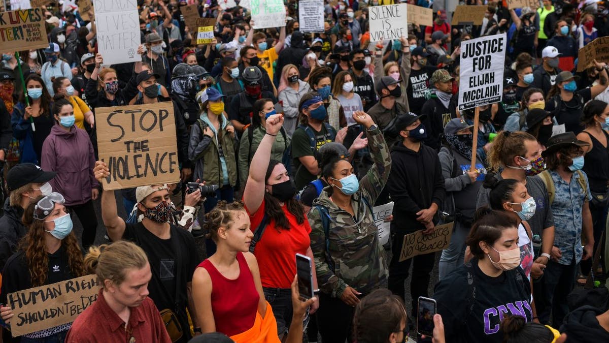 People march in the street to protest the death of Elijah McClain in Aurora, Colorado. 