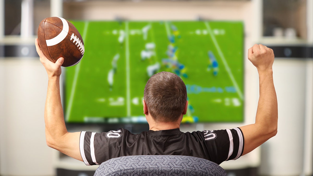 man watches football on TV