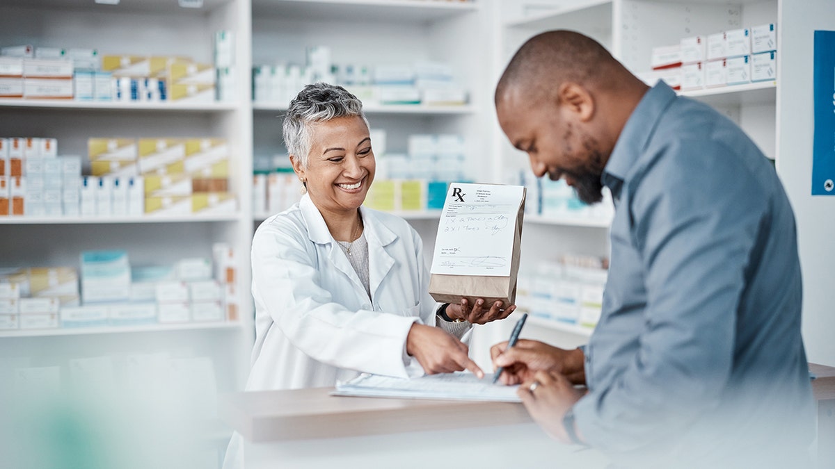 pharmacist helps a customer