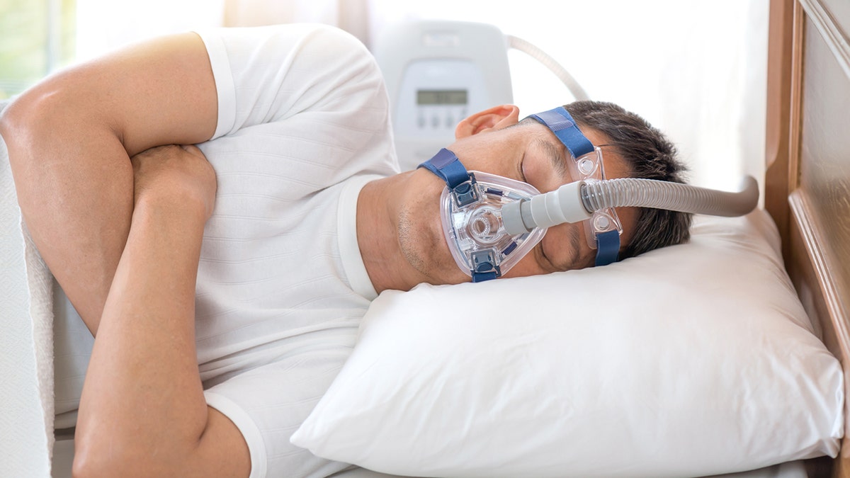 man sleeping in cpap mask