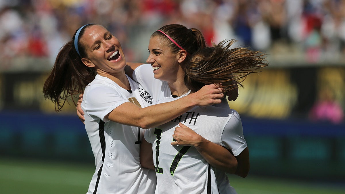 Lauren Holiday and Alex Morgan celebrate