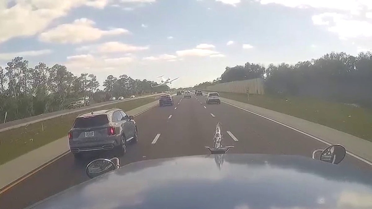 plane flying low over I-75