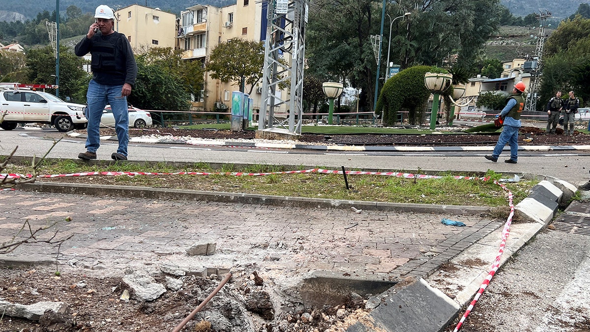 Workers survey area where rocket landed in Lebanon