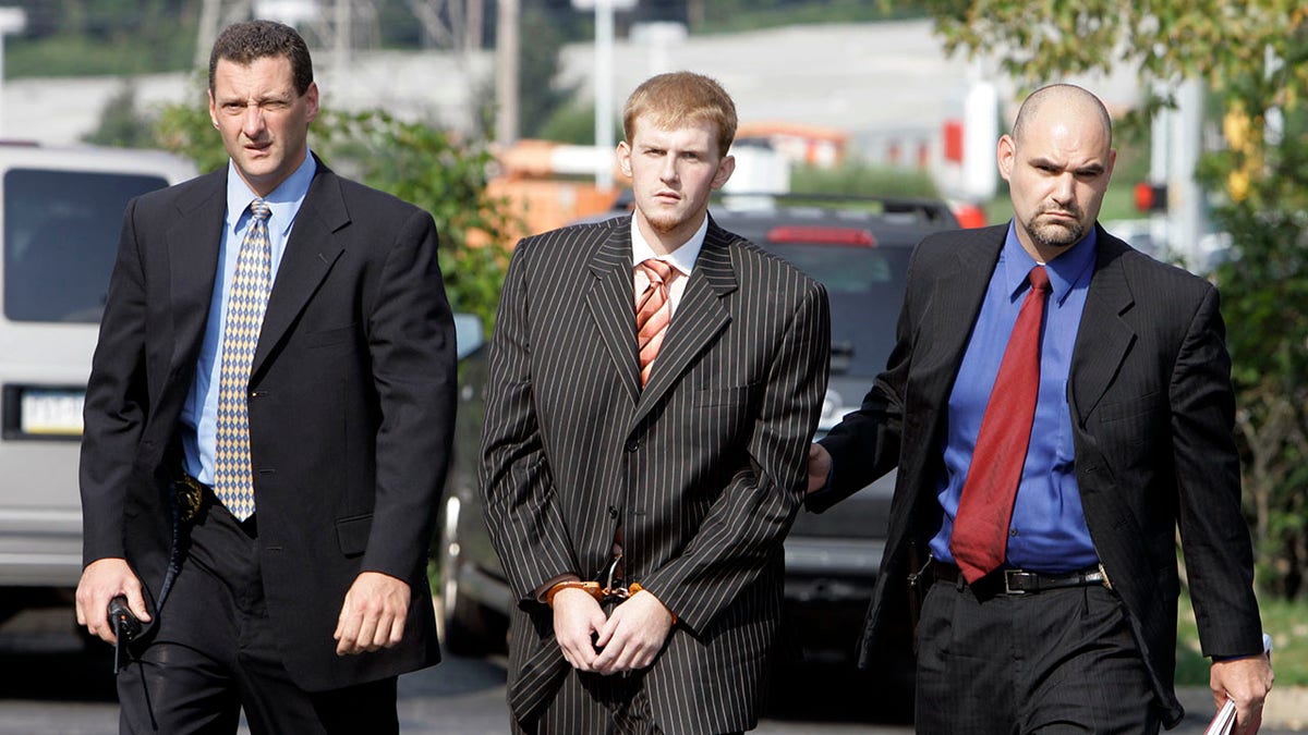 Britt Reid is escorted into the court house