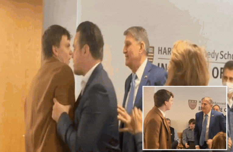 Sen. Joe Manchin squares up against climate activist before the agitator gets shoved out of the room