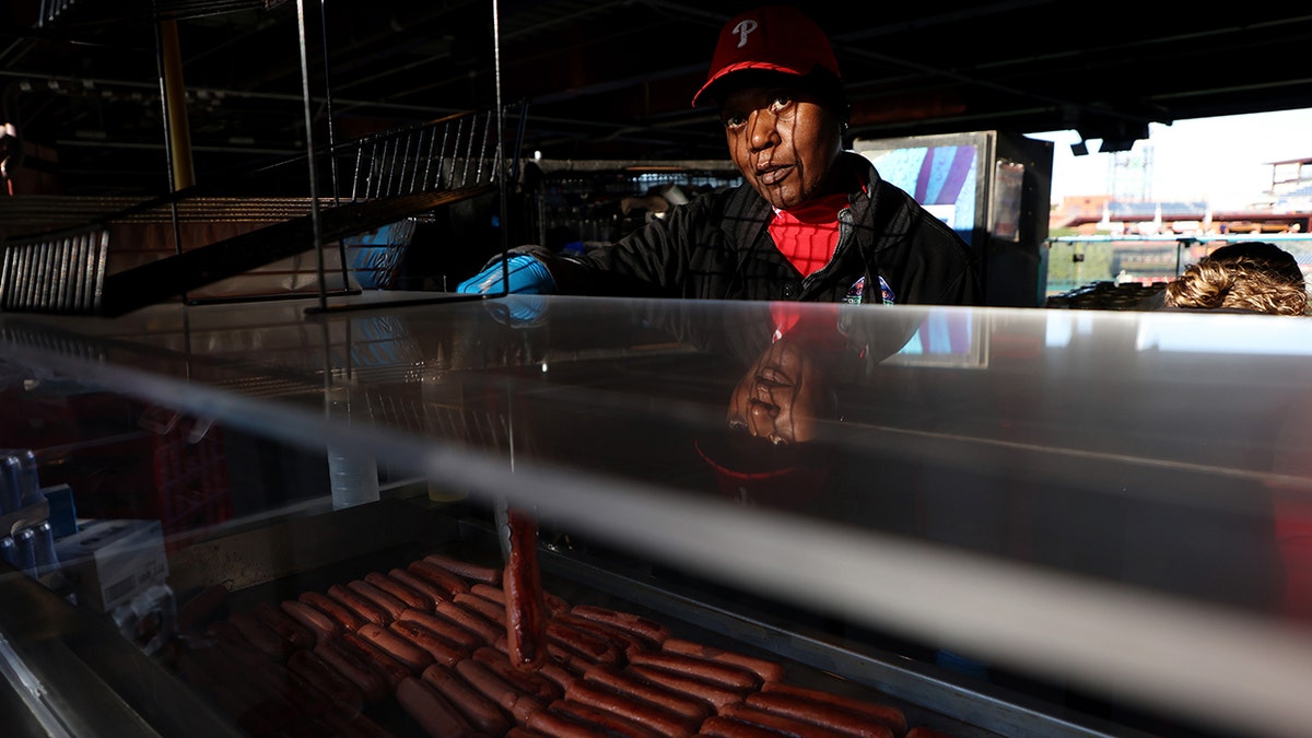 Phillies staffer works hot dog grill