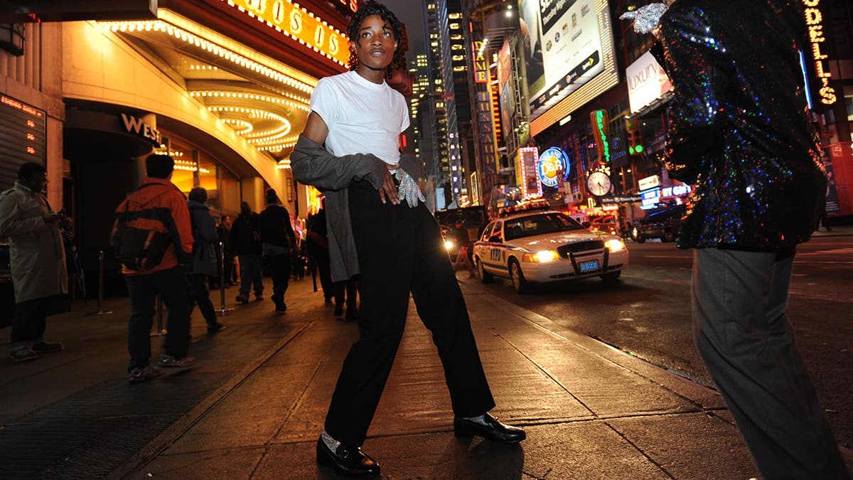 Two Michael Jackson impersonators on the street in at night