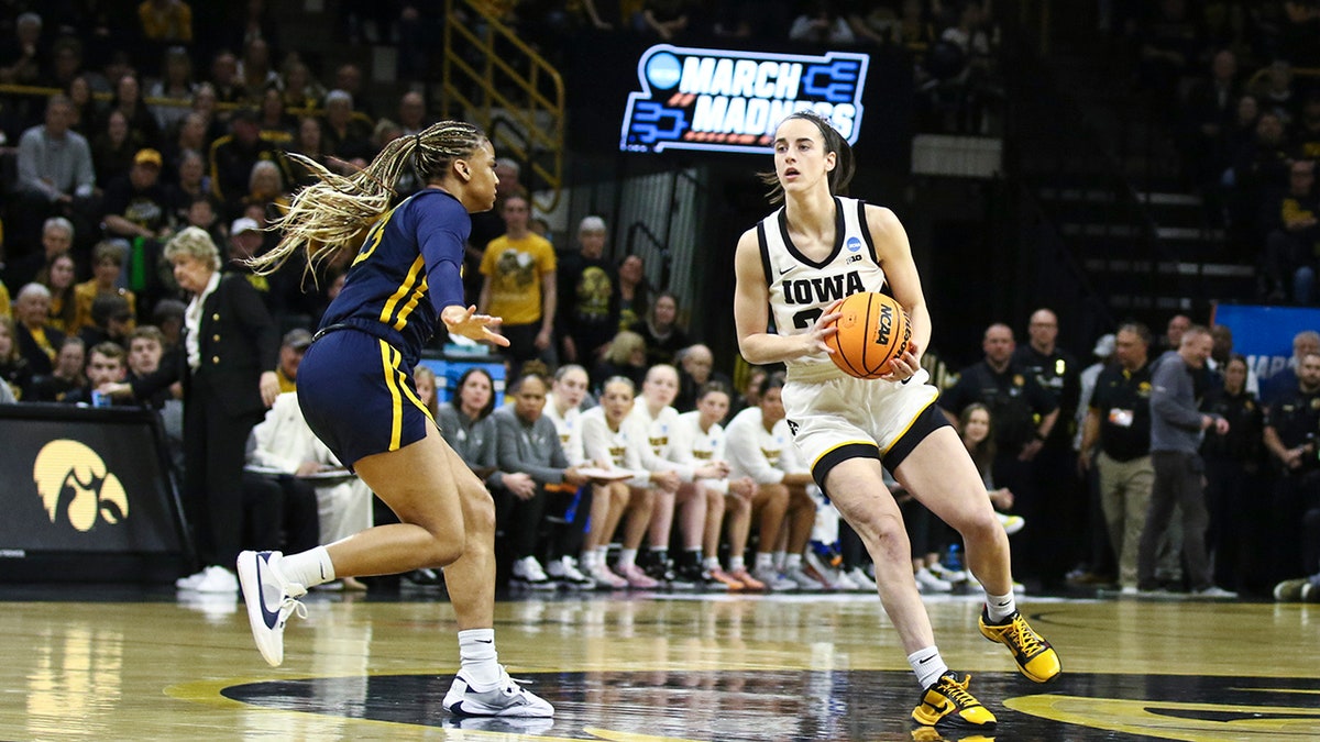 Caitlin Clark runs down court