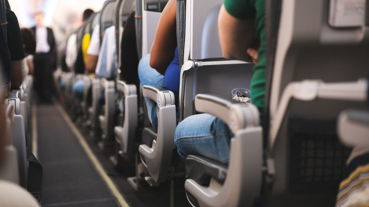 Interior of airplane with passengers on seats