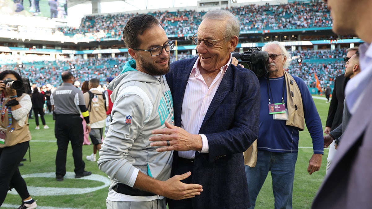 Dolphins owner Stephen Ross hugs McDaniel