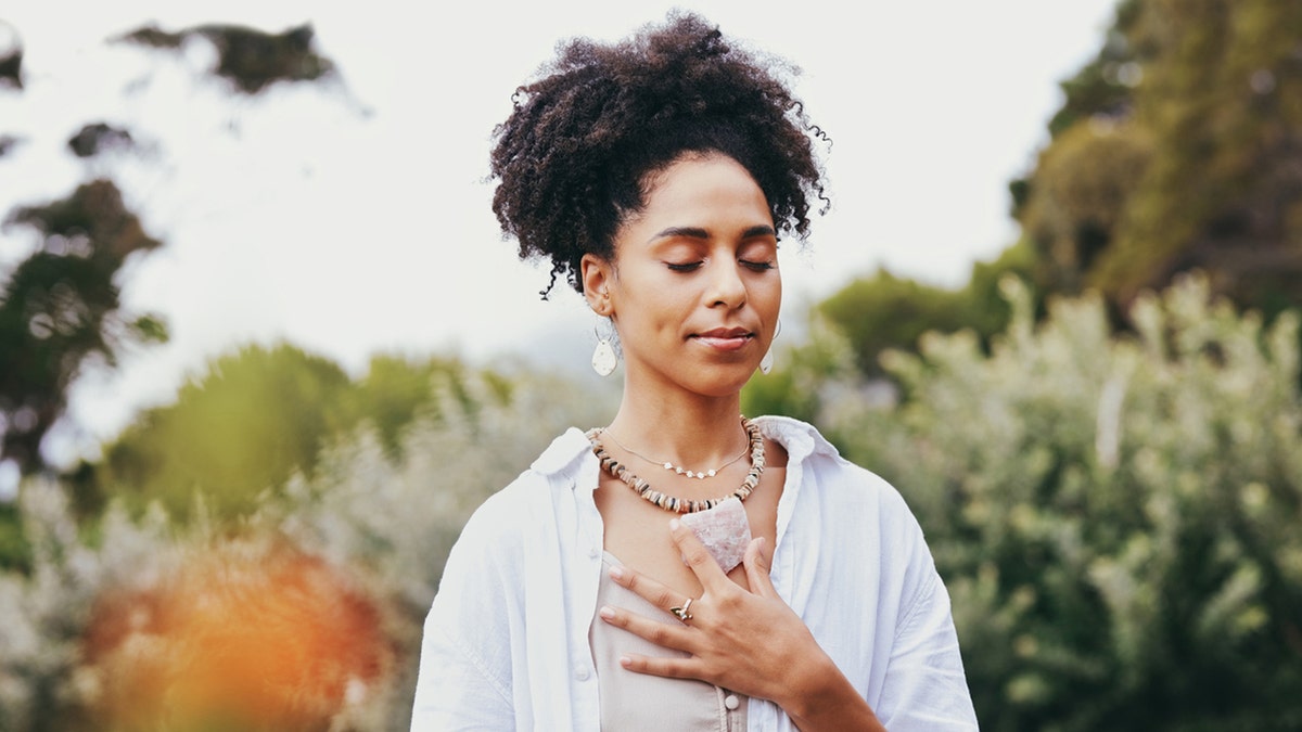 woman holding chest