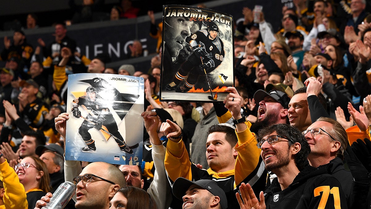 Fans hold up Jaromir Jagr posters