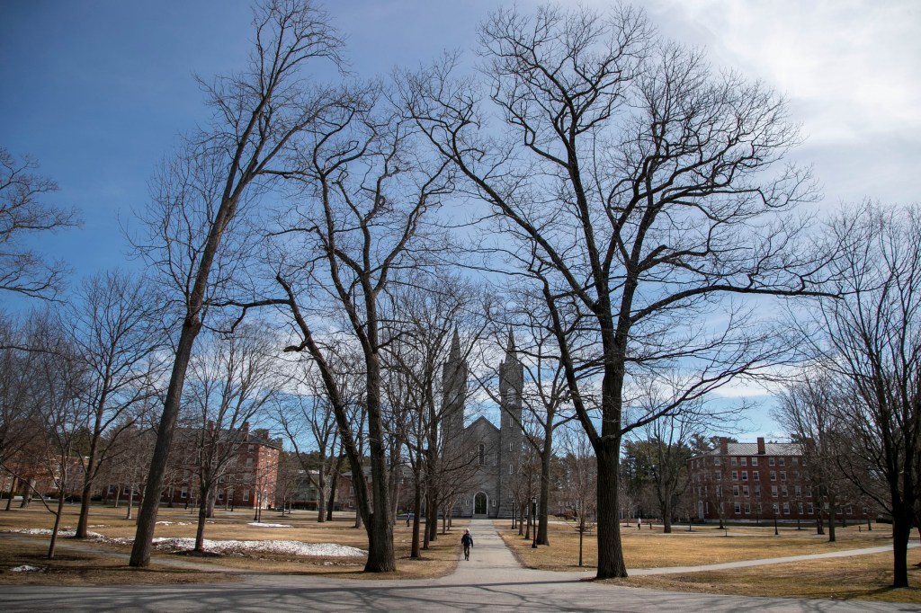 Person walking on a nearly empty Bowdoin College campus during spring break due to coronavirus concerns in Brunswick, Maine.